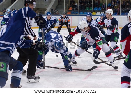 MOSCOW - JANUARY 28, 2014: Denis Mosalyov (54) fight for puck during the KHL hockey match Dynamo Moscow vs Slovan Bratislava in sport palace Luzhniki in Moscow, Russia. Final score 2:3