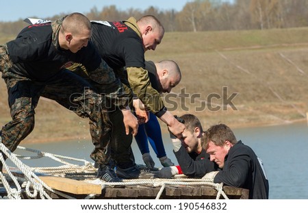 RUSSIA, DMITROV REGION, SHUKOLOVO VILLAGE - APRIL 26: Unidentified men on net stair on survival festival game NaPredele (On the edge) on April 26, 2014, in Dmitrov region, Shukolovo village, Russia