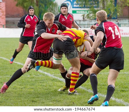 MOSCOW - MAY 13: Denis Kovtun (7) fall down on Russian Rugby Championship 2014 game Slava CSP (yellow) vs Metallurg (black), on May 13, 2014, in Moscow, Russia