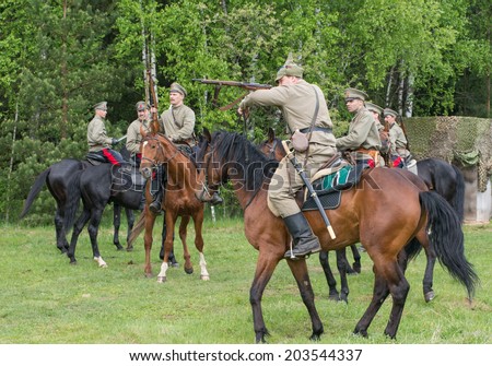 RUSSIA, CHERNOGOLOVKA - MAY 17: Cavalry soldier shooting rifle on History reenactment of battle of Civil War in 1914-1919 on May 17, 2014, Russia