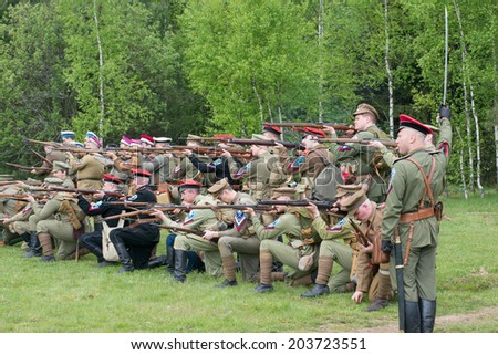 RUSSIA, CHERNOGOLOVKA - MAY 17: Kornilovs hiking squad shooting from rifles on History reenactment of battle of Civil War in 1914-1919 on May 17, 2014, Russia