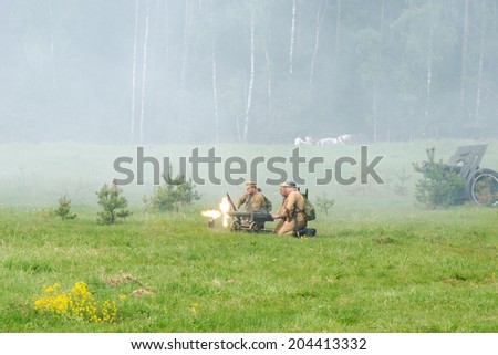 RUSSIA, CHERNOGOLOVKA - MAY 17: Unidentified soldiers shooting out of the Maxim machine gun on History reenactment of battle of Civil War in 1914-1919 on May 17, 2014, Russia