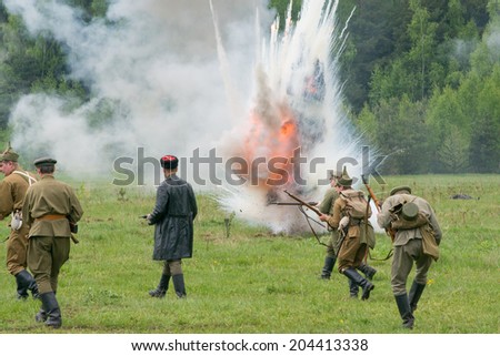 RUSSIA, CHERNOGOLOVKA - MAY 17: Unidentified men in military uniform run  under explosion attack on History reenactment of battle of Civil War in 1914-1919 on May 17, 2014, Russia