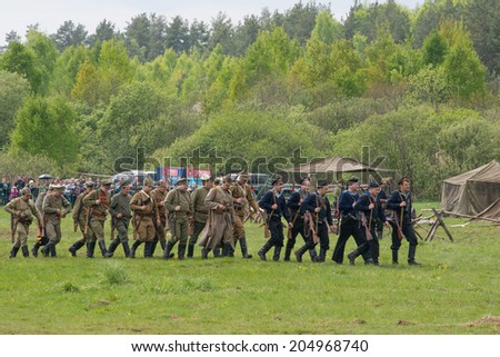 RUSSIA, CHERNOGOLOVKA - MAY 17: Unidentified men in military uniform attack the civil village on History reenactment of battle of Civil War in 1914-1919 on May 17, 2014, Russia