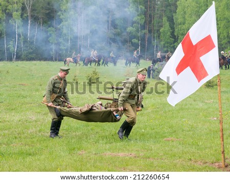 RUSSIA, CHERNOGOLOVKA - MAY 17: Unidentified men of medical squad move a wounded soldier on History reenactment of battle of Civil War in 1914-1919 on May 17, 2014, Russia