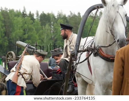 RUSSIA, CHERNOGOLOVKA - MAY 17: Unidentified men load machine gun on cart on History reenactment of battle of Civil War in 1914-1919 on May 17, 2014, Russia