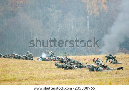RUSSIA, BORODINO - OCTOBER 12: Unidentified armed german soldiers lay down on the field on reenactment of the battle in WWII near the Borodino village in 1941,Borodino, on 12 October, 2014, Russia