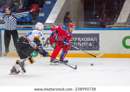 MOSCOW - DECEMBER 3: Logan Payet (39) vs Gharkov Pavel (25) on  game CSKA vs Severstal on Russian KHL premier hockey league Championship on December 3, 2014, in Moscow, Russia. CSKA won 9:1