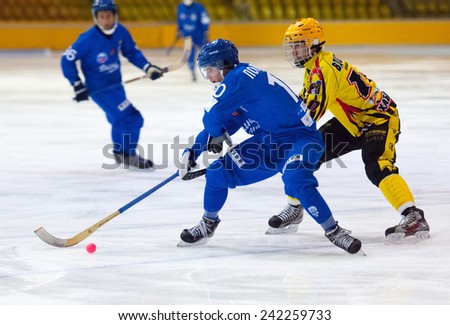 MOSCOW - DECEMBER 12, 2014: Poputnikov D. (10) attacks during the Russian  bandy league game Dynamo Moscow vs SKA Neftyanik in sport palace Krilatskoe, Moscow, Russia. Dynamo won 9:1