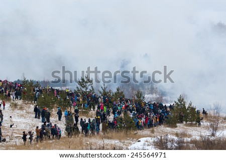 RUSSIA, LIZLOVO - DECEMBER 14: Unidentified civilian spectators of history reenactment on reenactment of the counterattack under the Moscow in 1941 in World War II, Lizlovo village, Russia, 2014