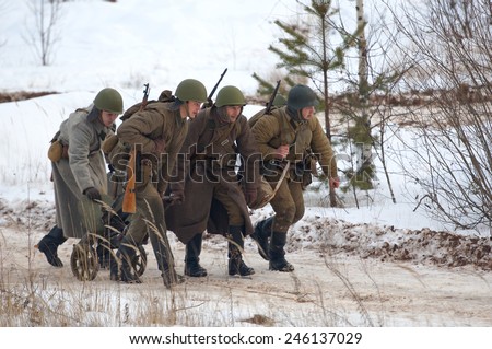 RUSSIA, LIZLOVO - DECEMBER 14: Unidentified soldiers transport the machine gun Maxim on reenactment of the counterattack under the Moscow in 1941 in World War II  Lizlovo village, Russia, 2014
