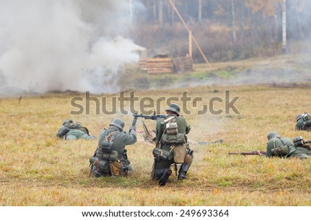 RUSSIA, BORODINO - OCTOBER 12: Unidentified armed german soldiers sit down on the field on reenactment of the battle in WWII near the Borodino village in 1941, in Moscow region, on 12 October, 2014
