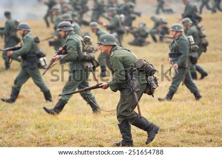 RUSSIA, BORODINO - OCTOBER 12: Unidentified armed german soldiers attack on the field on reenactment of the battle in WWII near the Borodino village in 1941, in Moscow region, on 12 October, 2014