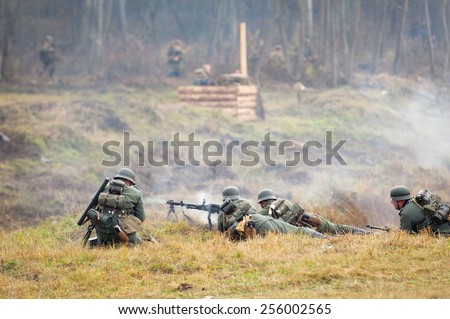 RUSSIA, BORODINO - OCTOBER 12: Unidentified armed german soldier shooting by machine gun on reenactment of the battle in WWII near the Borodino village in 1941, in on 12 October, 2014, Russia