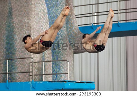 RUSSIA, MOSCOW - APRIL 29 2015: Athletes Vasiliy Raschiplyaev and Iliya Shekhman jumps from diving-tower in Pool on Moscow city diving tournament in Moscow, Russia, 2015