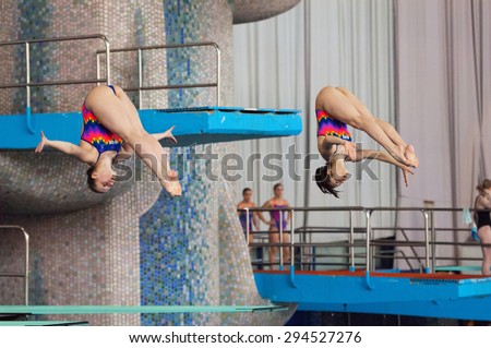 RUSSIA, MOSCOW - APRIL 29 2015: Athletes N. Aminieva and G. Sitnikova jump from diving-tower in Pool on Moscow city diving tournament in Moscow, Russia, 2015