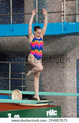 RUSSIA, MOSCOW - APRIL 29 2015: Athlete G. Sitnikova jumps from diving-tower in Pool on Moscow city diving tournament in Moscow, Russia, 2015