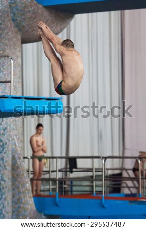 RUSSIA, MOSCOW - APRIL 29 2015: Athlete Sergey Nikolaev jumps from diving-tower in Pool on Moscow city diving tournament in Moscow, Russia, 2015