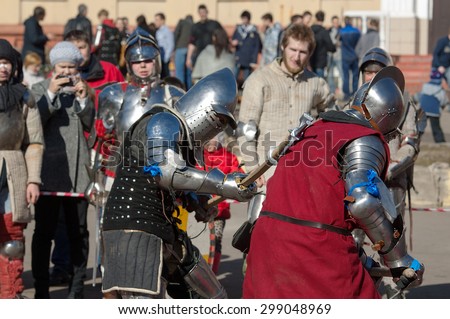 RUSSIA, MOSCOW - MARCH 14: Unidentified knight hit the back by axe fights by the axes on  tournament on history reenactment of the Medieval maneuvers in Moscow, 14 March, 2015, Russia