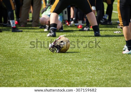 RUSSIA, TROITSK CITY - JULY 11: Unidentified Spartans throw a helmet on the grass on Russian american football Championship game Spartans vs Raiders 52 on July 11, 2015, Troitsk city, Russia