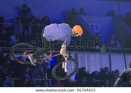 MOSCOW, RUSSIA - FEBRUARY 11: Unidentified bike trial rider completes at the festival of Extremals sports at Lugniki on February 11, 2012 in Moscow, Russia
