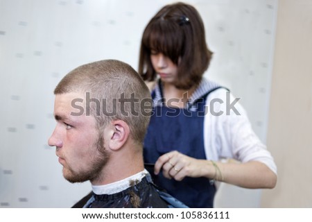 Barber cutting hair with clipper