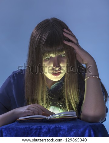 The girl reads the book also is surprised