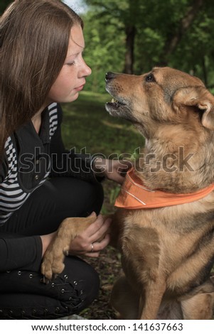 The girl talks to a dog