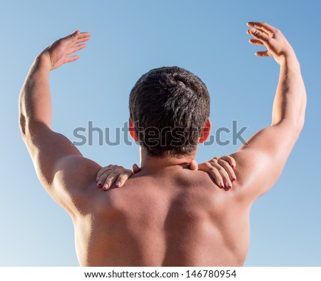 The man reaches for the sky on shoulders female hands