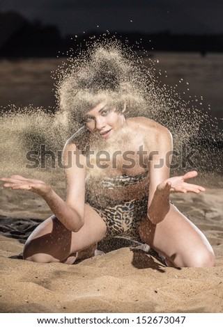 The girl throws sand