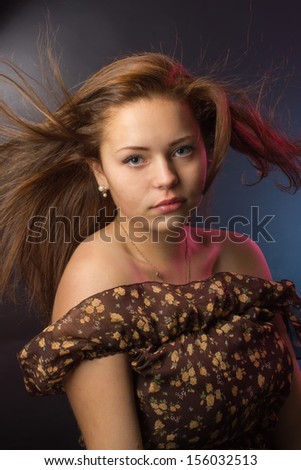 Portrait of the girl with fluttering hair