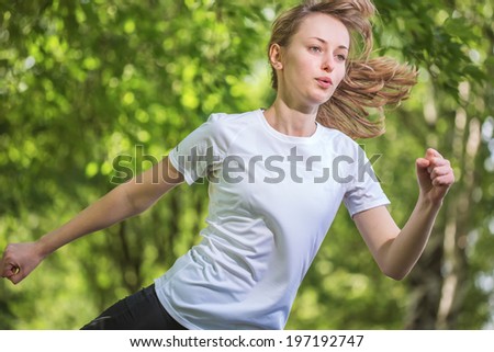The young beautiful woman runs on park