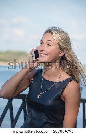 The girl talks on a cellular telephone