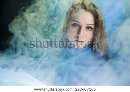Portrait of the girl in a smoke