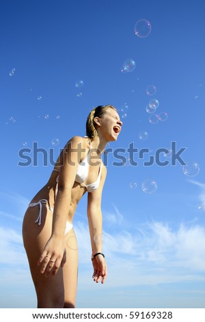 The girl catches a mouth soap bubbles