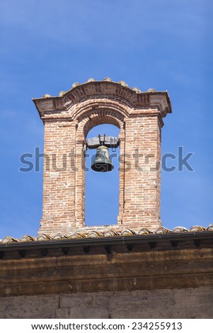 Small detail of a small church with a bell in Italy