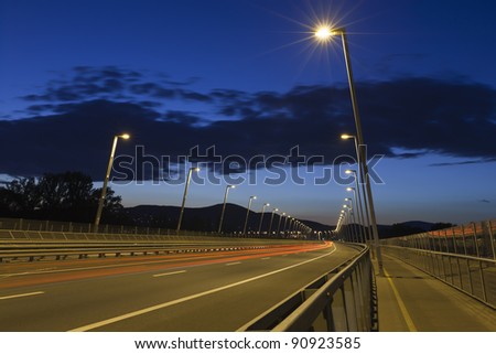 Row of lamp post at the end of a road bridge, night shot.