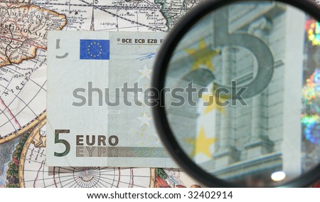 magnifying glass and paper currency
