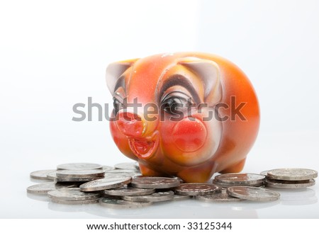 Piggy bank standing on  different copper and silver vintage coins