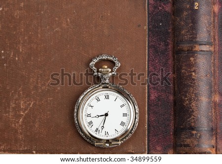 ancient book with pocket watch and compass and   copper coins