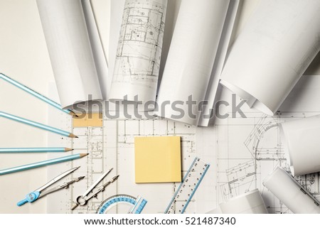 Workplace of architect - Architect rolls and plans.architectural plan,technical project drawing. Engineering tools view from the top. Construction background.