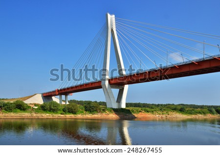 a big red and white bridge through the river Oka, Russia
