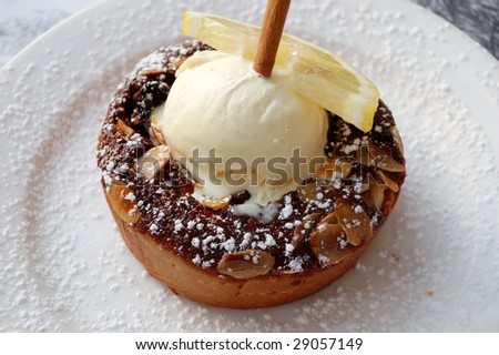 pie with almonds, piece of lemon and vanilla ice cream