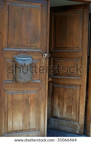 open wooden door with old mailbox
