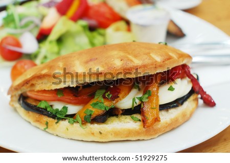 baked sandwich with eggs and vegetables on white plate
