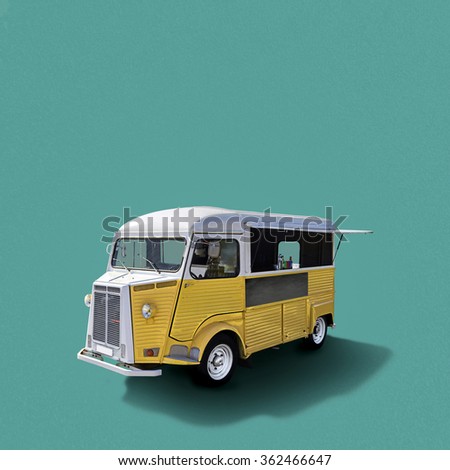 Yellow retro fast food truck on turquoise background, template with copy space