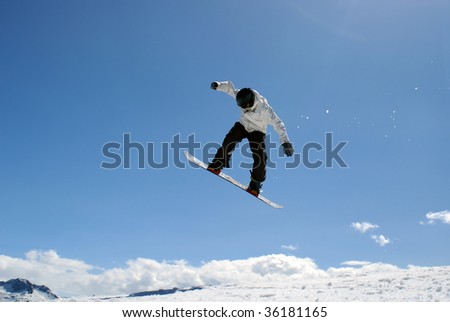 Snowboarder jump through air