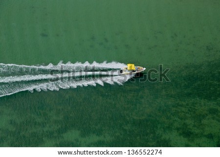 Aerial view of speeding boat on ocean