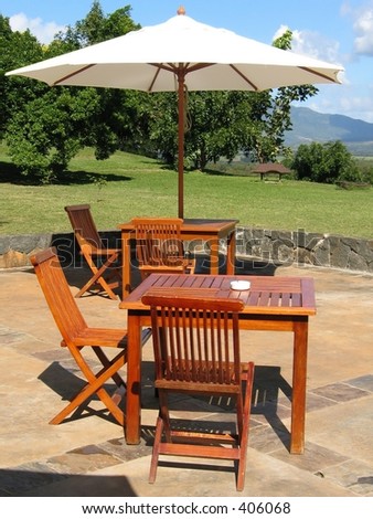 Wooden furniture covered by umbrella