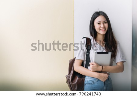 Portrait of Young Asian woman student with  laptop, Student and tutoring education with technology concept.